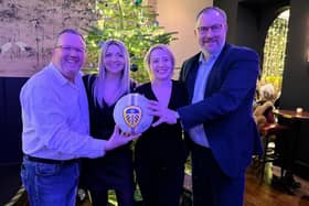 HRH Group MD Simon Cotton, Emily Roberts and Ashleigh Lambert of Cenheard and David Croft of Black Sheep with the signed Leeds United football.