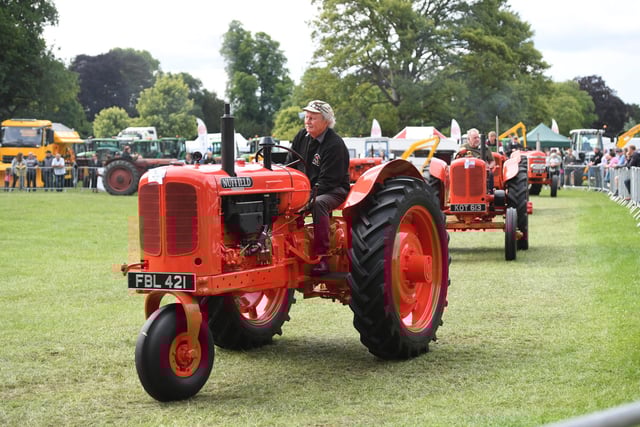 The vintage tractors on parade in the main ring at the festival