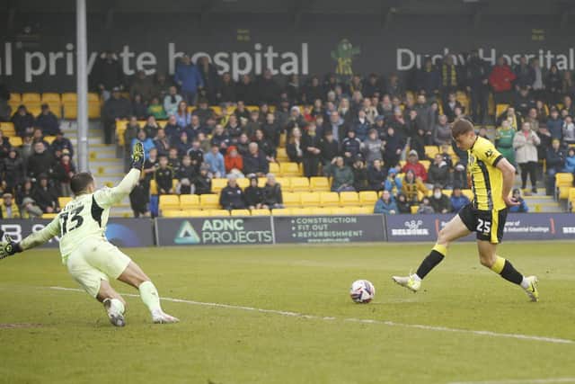 Tom Cursons slots home his second goal in Harrogate Town colours.