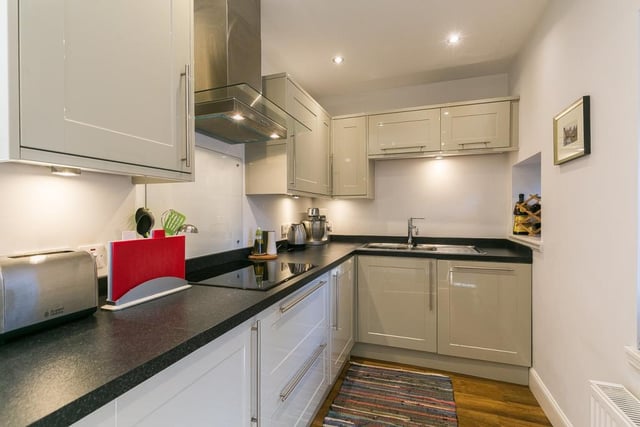 Integrated appliances in the kitchen include a washing machine, dishwasher, fridge/freezer, microwave, oven, an induction hob and extractor hood.