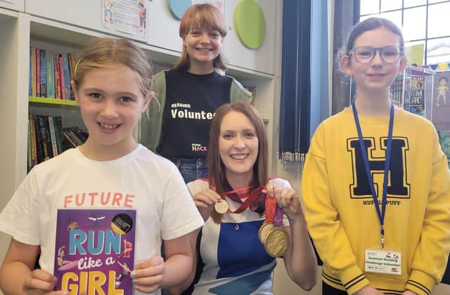 North Yorkshire-based Paralympian and author Danielle Brown with her gold medals and an honorary Ready, Set, Read medal.  Beth Kent, 12, and Emily Scott, 16, with Summer Reading Challenge participant Lucy Browne, seven, who holds Danielle's book, Run Like a Girl.