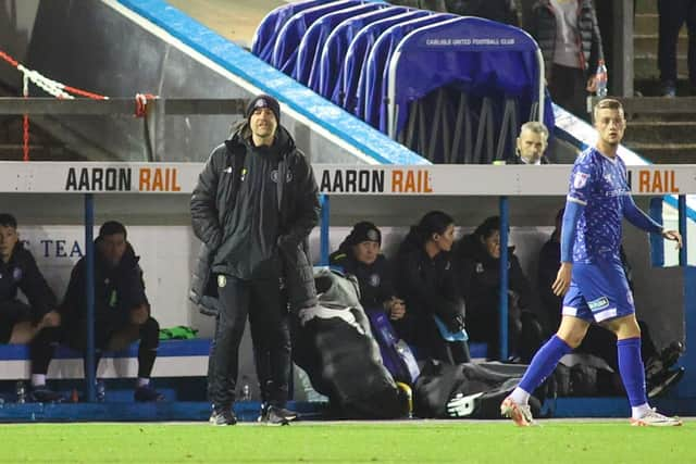 Harrogate Town manager Simon Weaver watches on from his technical area.