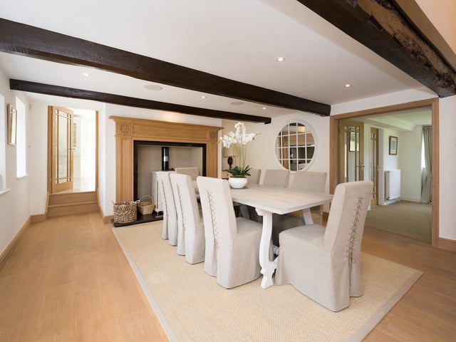 The beamed dining room, with feature fireplace and stove.
