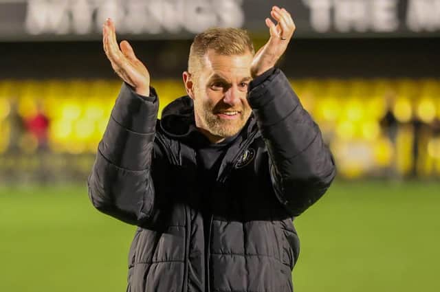 Harrogate Town manager Simon Weaver celebrates Tuesday night's thrilling 3-2 victory over Tranmere Rovers with the Sulphurites supporters. Picture: Matt Kirkham