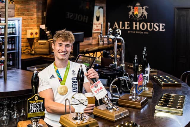 Jack Laugher MBE pulls a pint to mark the re-opening of the newly refurbished Ripon Inn.