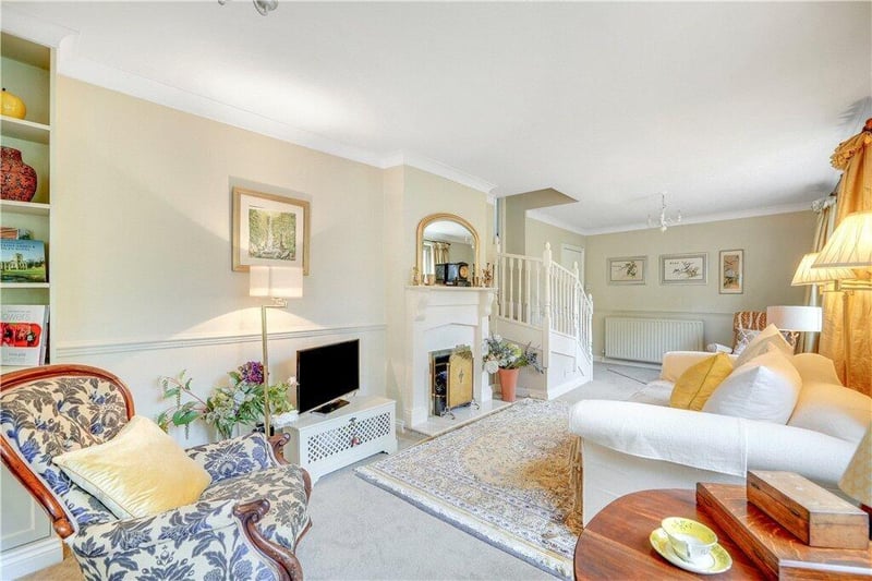 A spacious lounge with feature fireplace.