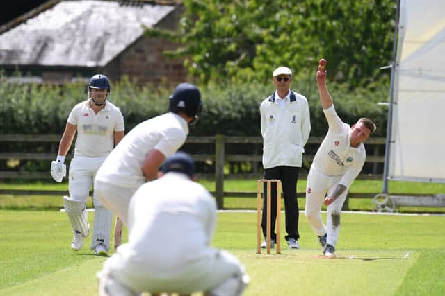 Chris Base bowling for Birstwith during their clash with Helperby.
