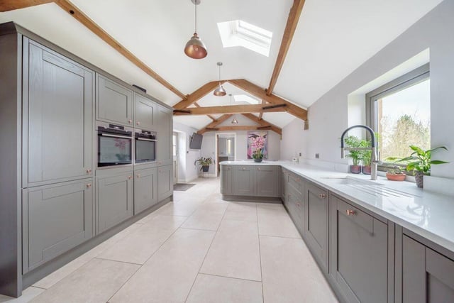 A sleek kitchen with granite worktops and integrated appliances.