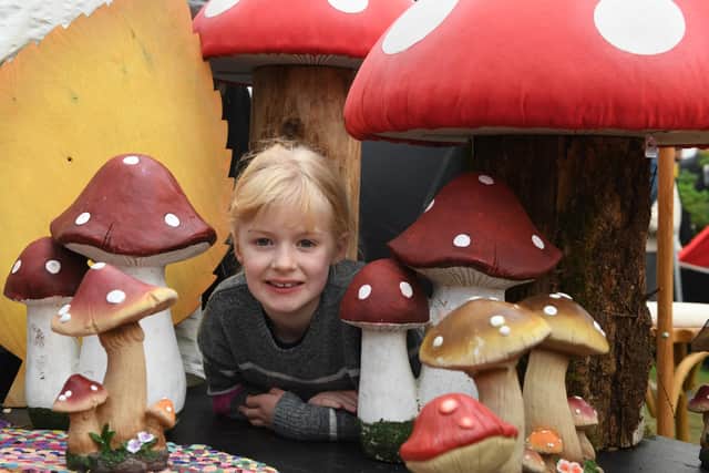Willow Herbert, aged seven, amongst the ornamental toadstools at the Harrogate Autumn Flower Show