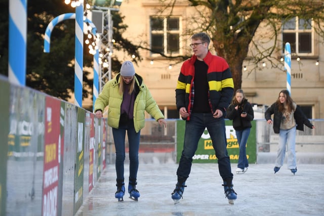 Visitors to the Christmas Fayre enjoying the outdoor ice rink which can be found in the Crescent Gardens
