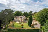 A view of the magnificent home in its landscaped grounds.