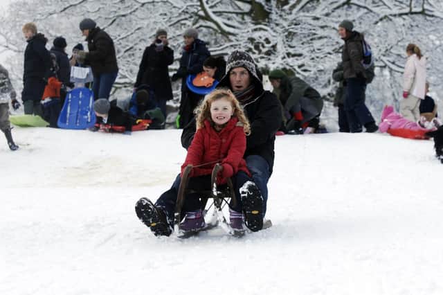 Children and their parents enjoying sledging down a hill in Harrogate back in 2010