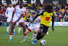 Harrogate Town forward Abraham Odoh finds his route to goal blocked by the Walsall defence. Pictures: Matt Kirkham