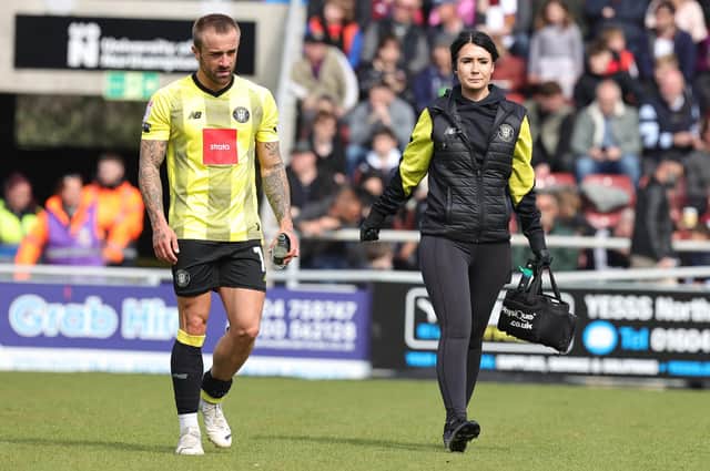 Alex Pattison leaves the pitch with Harrogate Town physio Rachel McGeachie during the first half of Saturday's 3-1 League Two defeat to Northampton at Sixfields. Pictures: Pete Norton/Getty Images