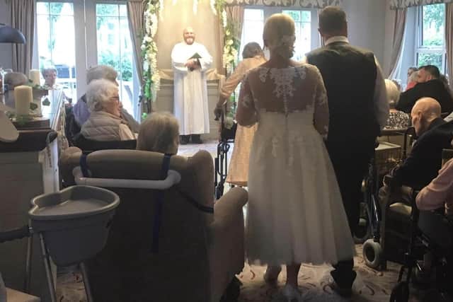 Staff members Joanne Meredith and Jim Doherty have their wedding blessed at The Manor House Knaresborough care home with residents and the Reverend Garry Hinchcliffe. (Picture The Manor House Knaresborough)