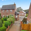 The detached house with its attractive front garden, and side driveway, has a village location.