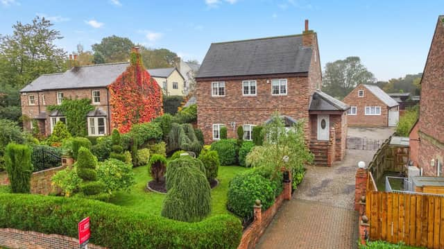 The detached house with its attractive front garden, and side driveway, has a village location.