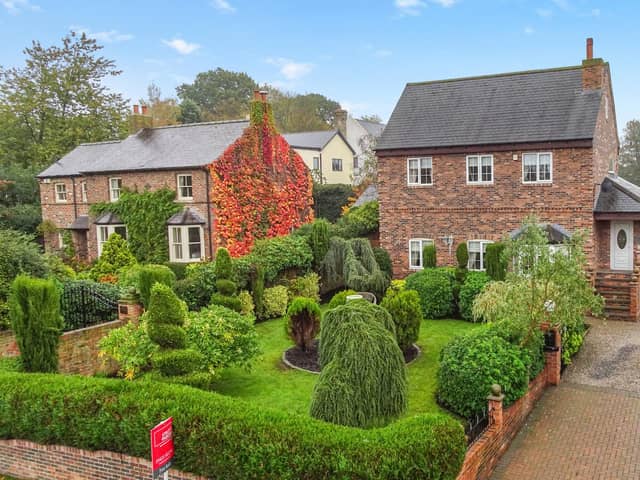The detached house with its attractive front garden, and side driveway, has a village location.