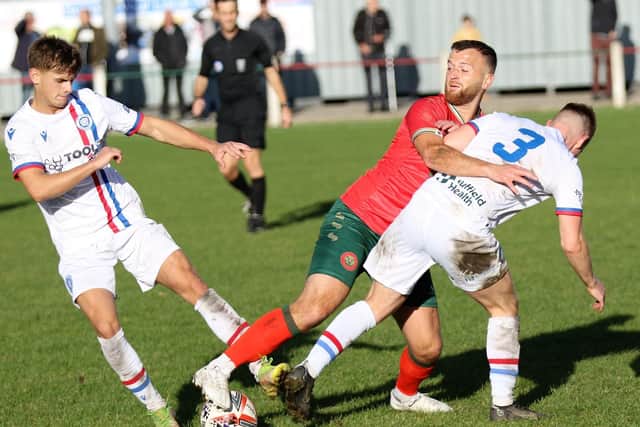 Harrogate Railway's Fatlum Ibrahimi scraps for possession in midfield.