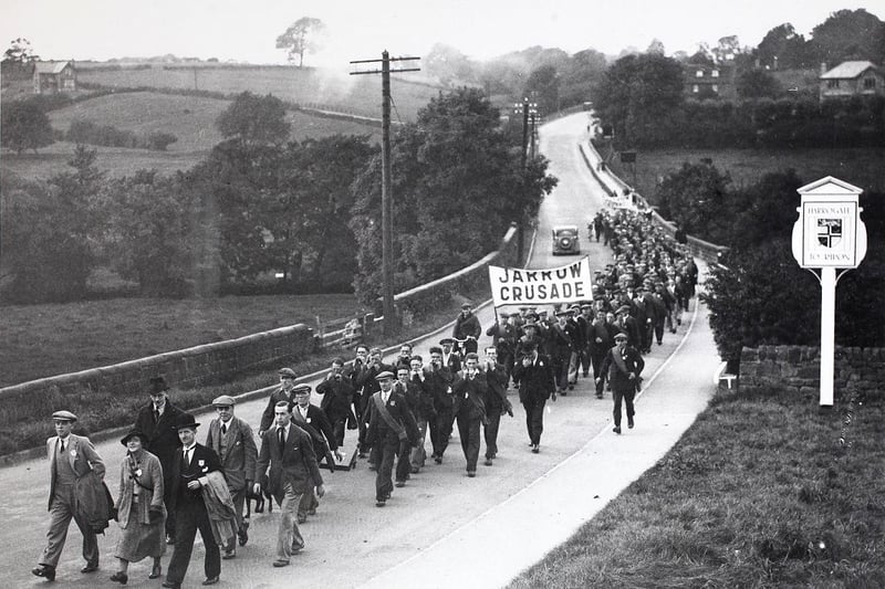 The Jarrow Marchers reach Harrogate on their journey to London, carrying a 'Jarrow Crusade' banner. On the journey from Ripon they were joined by Miss Helen Wilkinson M. P., who headed the march in October 1936.