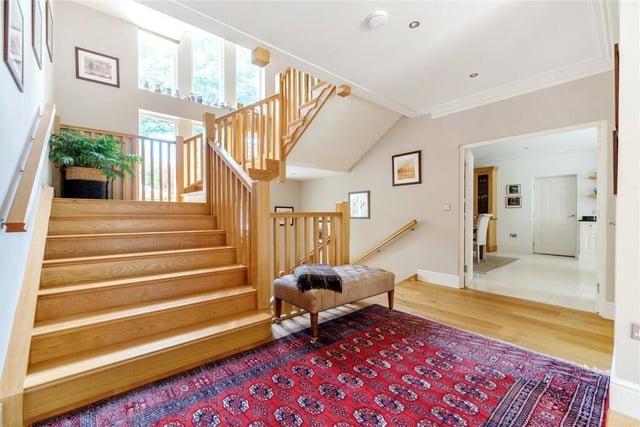 The entrance hall, with feature staircase leading both up to the first floor and down to the lower ground floor.