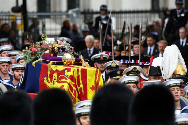 The coffin of Britain's Queen Elizabeth is carried in the procession to Westminster Abbey. (Photo by Hannah McKay- WPA Pool/Getty Images)