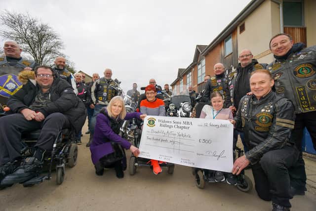 Visit by motorcycling Freemasons - Jackie Snape of Harrogate’s Disability Action Yorkshire, front left in purple, and Andrew Simister, far right standing, with members of the Widows Sons Ridings Chapter and Disability Action Yorkshire customers Eliza Bennet and Kirsty Allanach.