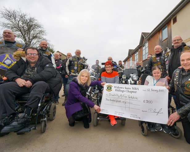 Visit by motorcycling Freemasons - Jackie Snape of Harrogate’s Disability Action Yorkshire, front left in purple, and Andrew Simister, far right standing, with members of the Widows Sons Ridings Chapter and Disability Action Yorkshire customers Eliza Bennet and Kirsty Allanach.