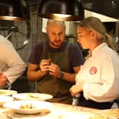 Abi cooking under the watchful eye of chef Tom Cenci in a previous round. Photo: BBC/Shine TV