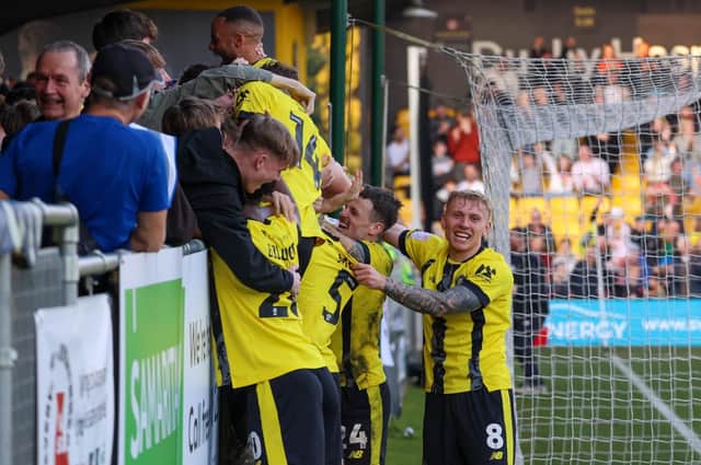 Harrogate Town players celebrate their last-gasp winner during Saturday's victory over Carlisle United. Pictures: Matt Kirkham