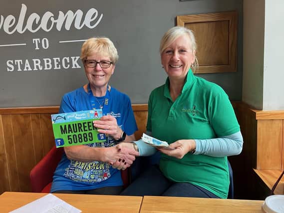 SI Harrogate member Maureen Ingleton hands over £800 after Great North Run to Dawn Cussons, manager of Harrogate Food Bank.