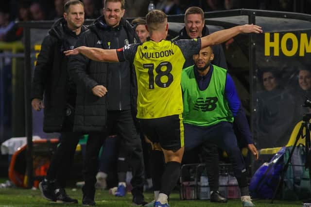 Jack Muldoon celebrates his recent goal against Swindon with the Sulphurites' bench.