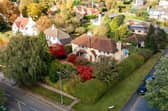 An overview of the distinctive property with its colourful garden.
