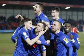 Harrogate Town's players celebrate Jack Muldoon's 50th-minute opener during Tuesday night's 1-1 draw at Salford City. Pictures: Paul Thompson/ProSportsImages