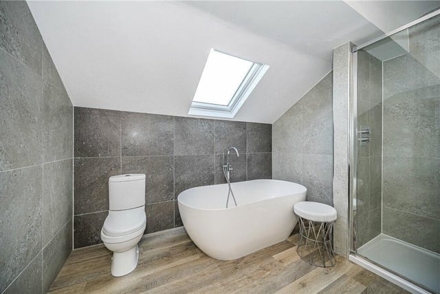 A contemporary bathroom with free standing bath tub.