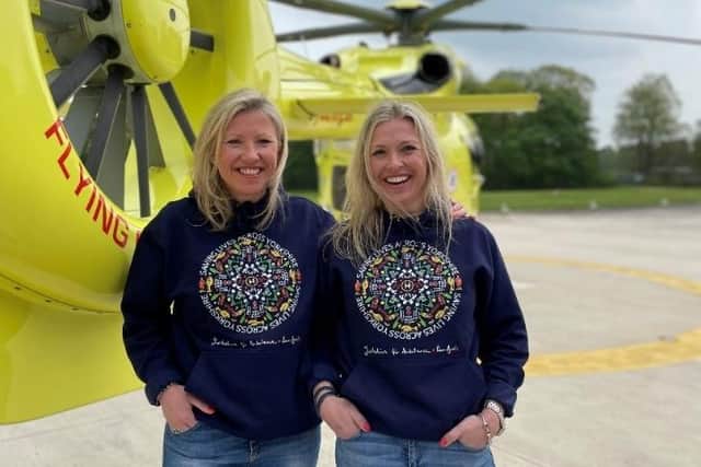 Luce and Bear founders, Lucy and Clare Bulmer wearing their Yorkshire Air Ambulance collaboration hoodie at a presentation in Wakefield.