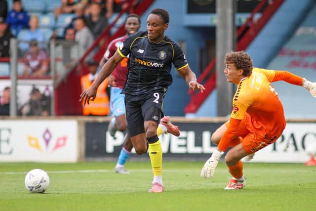 Shawn McCoulsky rounds Iron goalkeeper Louis Jones on his way to putting the Sulphurites 2-0 up at Glanford Park.