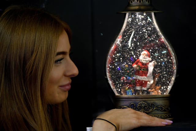 Holly Fisher from SnowTime looking at a Glow Santa