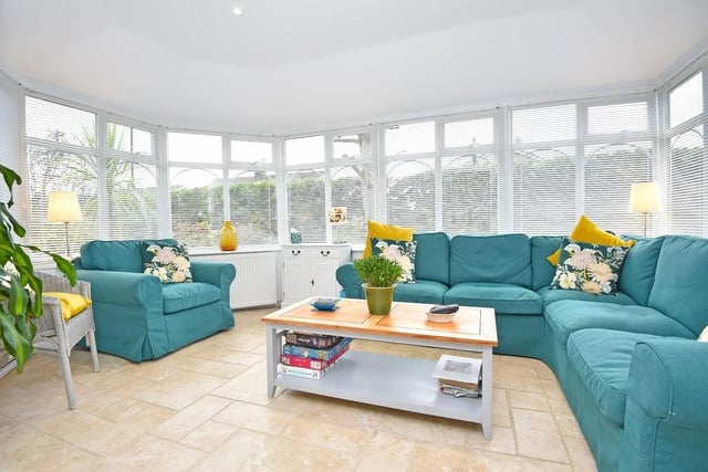 The sun room extension has all-round views of the lawned garden.