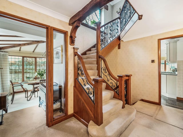 The hallway, with feature oak and wrought iron staircase.