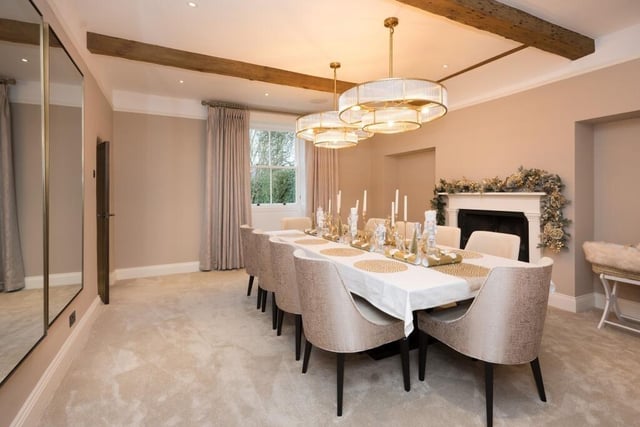 A sizeable dining room with feature fireplace.