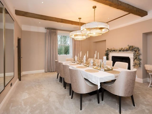 A sizeable dining room with feature fireplace.