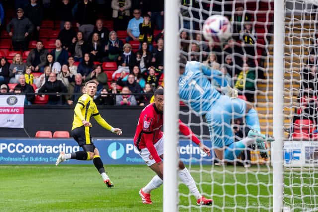 Josh March looks on as his sensational first-time strike beats Walsall goalkeeper Tommy Simkin.