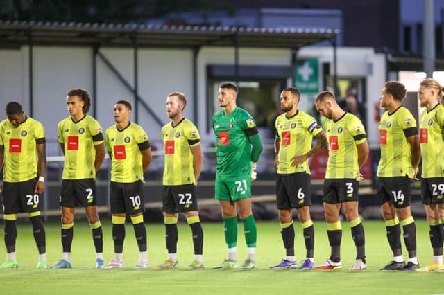 Harrogate Town's players observe a minute's silence in memory of the late Queen Elizabeth II prior or Tuesday night's League Two defeat to Salford City at Wetherby Road. Pictures: Matt Kirkham