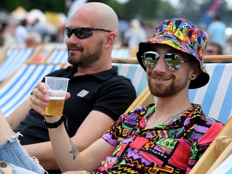 Ben Addison enjoying a beer on the deckchairs in the sunshine at the festival