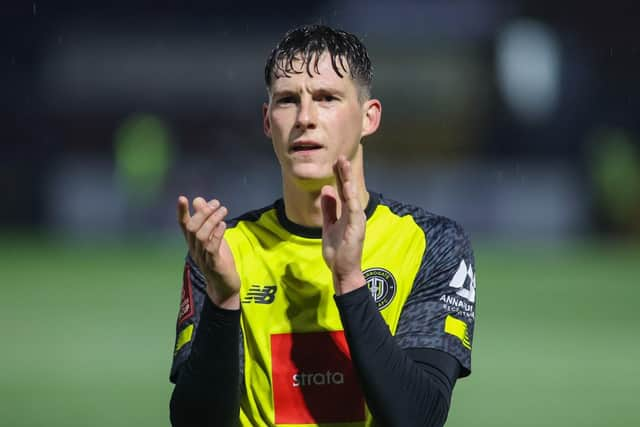 Sulphurites left-back Matty Foulds applauds the away supporters after the full-time whistle.