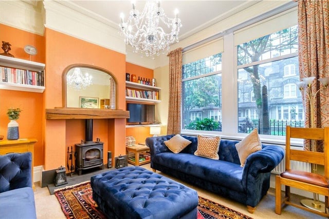 A spacious, light sitting room with built-in shelving.