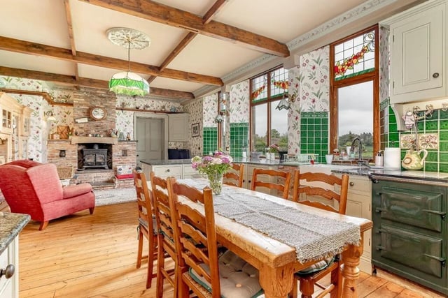The dining area and lounge with log burner to the rear.
