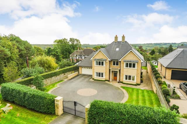 A front view of the imposing property that has mostly greenbelt land to its rear.