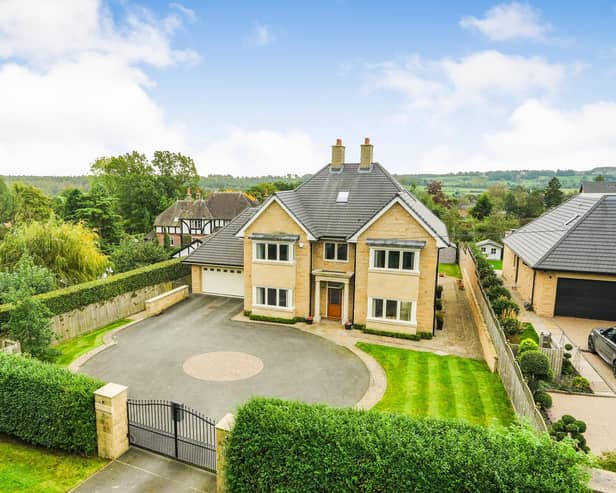 A front view of the imposing property that has mostly greenbelt land to its rear.